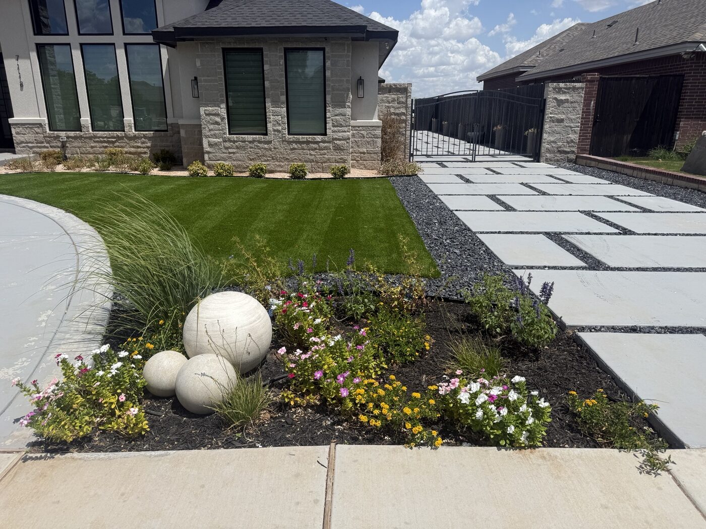 Colorful flower bed beside a landscaped front lawn